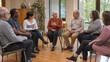 © AlenaSi - Group therapy session with elderly individuals discussing health issues and support in comfortable setting. Participants include diverse seniors sharing experiences in safe environment.