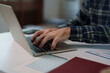 © Tj - Person typing on laptop, managing business finances and documents, working from home or office, showing hands on keyboard, performing remote work, online learning, and data entry