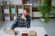 © Tj - Mature man deeply focused, working with financial documents and a laptop, analyzing data and managing his workload in a well-lit office environment