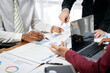 © Freedomz - Three men are sitting at a table with papers and laptops