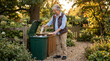 © Matos - Elderly woman recycling plastic bottles in a garden during golden hour