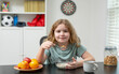 © Volodymyr - Happy kid eating breakfast. Child eating food at table. Smiling child enjoying food. Kid eating cereal with milk. Healthy food for child. Child portrait eating breakfast. Balanced breakfast nutrition.