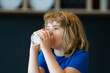 © Volodymyr - Child drinking glass of milk at home. Kid enjoying healthy dairy milk drink at kitchen. Happy child with milk glass. Child nutrition concept with glass of milk.