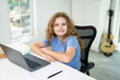 © Volodymyr - Laptop supports online school learning. Laptop lesson helps young student. Child laptop study looks focused. School laptop connects remote education.