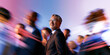 © Parisa - Smiling Asian Executive With Glasses Looking Forward Through Blue Pink Business Crowd Blur
