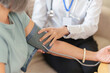 © Natee Meepian - Nurse checking senior woman blood pressure during home medical exam