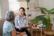 © Natee Meepian - Asian female doctor consulting senior woman patient during home visit for healthcare routine
