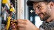 © Sergey - Close up of a skilled male electrician installing a smart electrical control module inside a modern building, concentrated expression, detailed hands