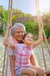 © IndiaPix - Grandmother swinging her daughter