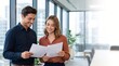 © Ben photography Ai - Business team of two happy young busy diverse colleagues, professional business man and business woman executives working together standing in office looking at project documents and talking.