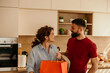 © La Famiglia - Happy couple returning home with shopping bags