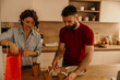 © La Famiglia - Couple unpacking takeout food for dinner in kitchen