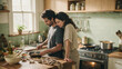© LarisaM - A couple cooks together in a bright home kitchen, preparing fresh ingredients while enjoying a relaxed and affectionate everyday moment.