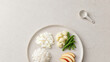 © rungnapha - Healthy diabetes friendly meal with egg white cauliflower green bean apple and rice on plate with spoon on marble background