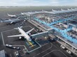 © Solonery Tech - Isometric view of smart airport terminal with glowing passenger flow lines and airplane docked at gate
