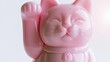 © Bonsales - Pink lucky cat figurine raising paw, symbolizing good fortune and prosperity on a clean background