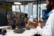 © DC Studio - Developer joins a team video call and adjusts deep learning parameters to automate tasks as technology company employees discuss AI-driven insights with colleagues during the online meeting.