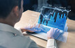 © InfiniteFlow - A business professional engages in data analysis using a laptop, featuring digital graphs and charts to assist in financial decision making and strategy formulation. Scalp