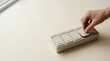 © KohXD - Person's hand deliberately pressing a button representing focused attention allocation throughout the week