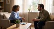 © StillWave - Young couple having serious conversation on living room sofa with conversation