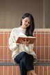 © mojo_cp - Beautiful Asian woman reading book in outdoor