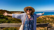 © Jacek Chabraszewski - Happy mature woman tourist standing at viewpoint to Monte Clerigo beach on Algarve coast on sunny spring day. Front view