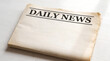 © Nusrat - A folded copy of the daily news newspaper on white background with newspaper journalism information headline background communication document publication