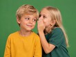 © Pavel Semin - Two children sharing a secret, smiling, on a green background