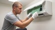 © Eduardo - air conditioning Professional technician performing maintenance on a residential wall mounted air conditioning unit