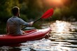 © Daria - Man kayaking on calm water during golden hour with sunlight reflecting and droplets falling from paddle in serene natural setting