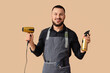 © Pixel-Shot - Male hairdresser with hair dryer and spray on beige background