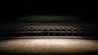© wilson - Empty theater auditorium with rows of dark seats illuminated by a narrow soft warm beam of stage light from the front before a performance or movie starts