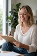 © miss irine - Smiling woman writes notes on clipboard indoors. She is dressed casually, planning tasks at home with natural light. Focused, productive, and happy lifestyle.
