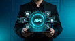 © MdSuhel - Businessman holding application programming interface API software integration network concept