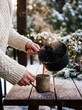 © AdPremium - Person in a cozy knit sweater pouring hot steaming mulled wine from a pot into a rustic mug on a snowy wooden table outdoors