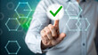© SHAFIA - Professional hand selecting green checkmark on digital hexagon network interface for approval