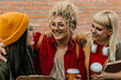 © La Famiglia - Diverse students laughing and bonding with coffee cups