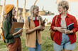 © La Famiglia - Diverse university students talking and laughing on campus