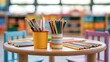 © Tanvir - Colored pencils and brushes in holders on a children classroom table. Back to school education concept.