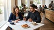 © SashaMagic - Business colleagues discussing documents over breakfast at cafe with croissants and coffee, collaboration concept