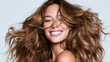 © Newleks - Woman with beautiful voluminous brown hair, smiling brightly and confidently, showcasing healthy skin and a joyful expression, symbolizing beauty, wellness, and self care