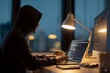 © Анна Мартьянова - Anonymous hooded programmer coding late at night on laptop and monitor, representing cybersecurity, hacking, and software development in a dark tech workspace.