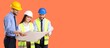 © Pixel-Shot - Three smiling construction engineers in hard hats and safety vests reviewing blueprints on an orange background, They are engaged in a discussion about a building project plan