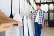 © Serhii - Man selecting decorative plaster samples for home renovation