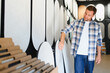 © Serhii - Man choosing decorative plaster samples for home improvement