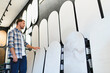 © Serhii - Man choosing decorative wall panels for home renovation