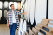 © Serhii - Man selecting decorative plaster finish in studio showroom