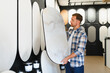 © Serhii - Man choosing decorative plaster sample for home renovation