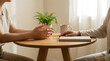 © Rashida Visuals - Two people sitting at a wooden table having a conversation in a bright and cozy home office setting