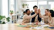 © Alva - Diverse group of happy young professionals celebrating success with a high five in a modern bright office.